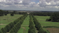 Long Approach To Burghley House Through Trees Along Avenue Then Circle The House - 2 Minutes Long