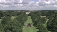 Long Approach To Burghley House Through Trees Along Avenue Then Circle The House - 2 Minutes Long
