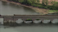 Steam Train Passing Over Lake On Bridge