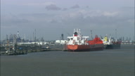 Humber Oil Refinery Reveal From Low Shot Behind Ships