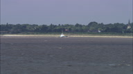 Focus On Small Boat Then Ascend-Reveal Past Humber Suspension Bridge In C/U And Zoom Out