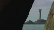 Longships Lighthouse Through Whole In Rock