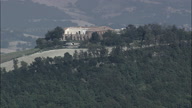 Pull Out From Old Big Farmhouse On Hills On The Way To Fossombrone