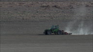Close Low Level Shot Of Tractor At Work In Field