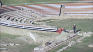 Metaponto - Greek Home Of Pythagoras Archeological Site And Ruins Pull Out From Greek Theatre Ruins With Tourists