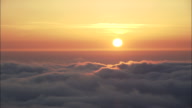 Rising Above And Descending Into The Clouds At Sunset