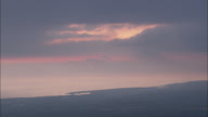 Rising Above And Descending Into The Clouds At Sunset