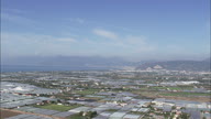 Polly Tunnels And Greenhouses On The Way To Salerno With Bay In The Background