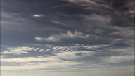 Wispy Cirrus Clouds In Blue Sky Near Ischia Island