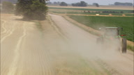 Following A Tractor On A Dirt Road