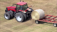 Tractor Stacking Hay Bales